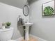 Powder room features a pedestal sink, decorative mirror, modern lighting, and stylish decor at 886 Friendly Cir, Charleston, SC 29414
