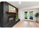 Living area features a black brick fireplace with a wood mantle and access to a screened-in porch at 886 Friendly Cir, Charleston, SC 29414