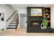 Unique black brick fireplace paired with modern staircase showcasing the home's architectural details at 886 Friendly Cir, Charleston, SC 29414