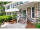 Welcoming front porch with brick steps, a painted green door, and beautiful brick facade at 886 Friendly Cir, Charleston, SC 29414