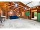 Spacious garage interior with exposed wooden beams, natural light, and a cozy blue couch at 886 Friendly Cir, Charleston, SC 29414