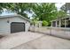 Detached garage with a gray garage door and a white picket fence at 886 Friendly Cir, Charleston, SC 29414