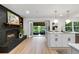 Modern kitchen featuring a sleek island, contemporary lighting, and a view to an outdoor seating area at 886 Friendly Cir, Charleston, SC 29414