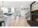 Open concept kitchen with white cabinetry, stainless appliances, and a view into the home's living and entry areas at 886 Friendly Cir, Charleston, SC 29414