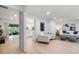 Open living room with light wood floors, modern white furniture, and seamless transition to an outdoor area at 886 Friendly Cir, Charleston, SC 29414