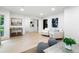 Bright living room with white walls and wood floors, featuring stylish seating and views to staircase and backyard at 886 Friendly Cir, Charleston, SC 29414