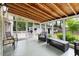 Screened-in porch with comfortable seating and views of the backyard and additional structures at 886 Friendly Cir, Charleston, SC 29414