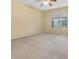 A spacious bedroom features a large window with wooded views and neutral colored walls and carpet at 8967 N Red Maple Cir, Summerville, SC 29485