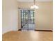 A naturally lit dining area features dark wood floors and sliding glass doors to a screened porch at 8967 N Red Maple Cir, Summerville, SC 29485