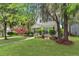 Attractive two-story home with a lush green lawn, mature trees, and a welcoming front entrance at 8967 N Red Maple Cir, Summerville, SC 29485