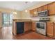 Well-equipped kitchen with stainless steel appliances, wood cabinets, and convenient backyard access at 8967 N Red Maple Cir, Summerville, SC 29485