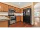 Functional kitchen featuring stainless steel appliances, wood cabinetry, and modern lighting fixtures at 8967 N Red Maple Cir, Summerville, SC 29485