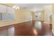 Expansive open living room features wood flooring, natural lighting from windows, and ceiling fans at 8967 N Red Maple Cir, Summerville, SC 29485