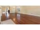Spacious living room featuring pristine wood floors, neutral walls, and natural light from a large window at 8967 N Red Maple Cir, Summerville, SC 29485