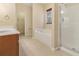 This bright main bathroom features a walk-in shower, soaking tub, and a vanity with generous countertop space at 8967 N Red Maple Cir, Summerville, SC 29485