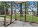 Screened porch with a view of the backyard trees at 8967 N Red Maple Cir, Summerville, SC 29485