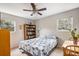 Cozy bedroom with a blue and white quilt, built-in bookcase, and windows offering natural light at 907 Pauline Ave, Charleston, SC 29412