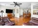 Open-concept living space featuring hardwood floors, a ceiling fan, and lots of natural light at 907 Pauline Ave, Charleston, SC 29412