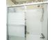 Bright bathroom featuring a shower with sliding glass doors and white tile surround at 930 Stiles Dr, Charleston, SC 29412