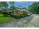 Brick home with a long driveway leading to a carport, surrounded by manicured landscaping at 930 Stiles Dr, Charleston, SC 29412