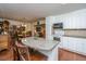 Open kitchen showcasing a granite-topped island and white cabinetry adjacent to dining and living spaces at 930 Stiles Dr, Charleston, SC 29412