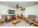 Comfortable living room featuring a leather sofa, patterned armchair, and a ceiling fan at 930 Stiles Dr, Charleston, SC 29412