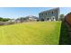 Spacious backyard with lush green lawn and a view of a two-story home at 9711 Fanning Basket Ln, Ladson, SC 29456