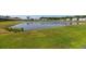 Scenic backyard pond view in a residential community with lush green lawn at 9711 Fanning Basket Ln, Ladson, SC 29456
