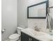 This is a bathroom including a dark vanity, a square mirror, and marble backsplash at 9711 Fanning Basket Ln, Ladson, SC 29456