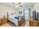 Charming bedroom with a wooden bed frame, soft blue bedding, and a large window for natural light at 9711 Fanning Basket Ln, Ladson, SC 29456