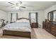 The main bedroom featuring soft carpet, dark furnishings, and natural light at 9711 Fanning Basket Ln, Ladson, SC 29456