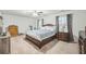 The main bedroom with soft carpet, dark furnishings, and natural light at 9711 Fanning Basket Ln, Ladson, SC 29456