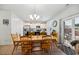Well-lit dining area features a chandelier and access to a rear patio at 9711 Fanning Basket Ln, Ladson, SC 29456