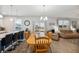 Bright open dining area with views of the kitchen, living room, and backyard at 9711 Fanning Basket Ln, Ladson, SC 29456