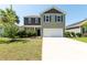 Charming two-story home featuring a spacious driveway and manicured lawn at 9711 Fanning Basket Ln, Ladson, SC 29456