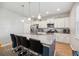 This is a kitchen featuring a granite top island, stainless steel appliances, and white cabinets at 9711 Fanning Basket Ln, Ladson, SC 29456