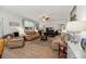 Bright living room with neutral tones, plank floors, and ceiling fan at 9711 Fanning Basket Ln, Ladson, SC 29456