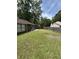 Large grassy backyard with a patio area and privacy fence at 100 Lexington Pl, Goose Creek, SC 29445