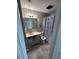 Bathroom with modern vanity, lighting, patterned shower curtain, and updated gray tile at 100 Lexington Pl, Goose Creek, SC 29445