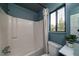 Bathroom featuring blue walls, a combination shower and tub, toilet, and a vanity with a mirror at 103 Four Iron Dr, Summerville, SC 29483