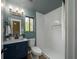 Bathroom with blue vanity, toilet, and stand up shower with white subway tiles at 103 Four Iron Dr, Summerville, SC 29483