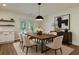 Dining room features a large wooden table with seating for six and modern lighting at 103 Four Iron Dr, Summerville, SC 29483