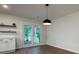 Bright dining area with doors leading to outdoor deck and modern lighting at 103 Four Iron Dr, Summerville, SC 29483