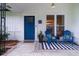 Inviting front porch with blue chairs, a black and white rug, and a stylishly painted blue front door at 103 Four Iron Dr, Summerville, SC 29483