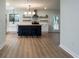 Open-concept kitchen features a black island, butcher block countertop, and stainless steel appliances at 103 Four Iron Dr, Summerville, SC 29483