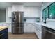 Modern kitchen boasts stainless steel appliances, white cabinets, and a farmhouse sink at 103 Four Iron Dr, Summerville, SC 29483
