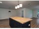 Spacious room featuring a black kitchen island with a butcher block top and modern lighting at 103 Four Iron Dr, Summerville, SC 29483