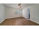 Simple room with ceiling fan, wood flooring, and door leading to an adjacent room at 103 Four Iron Dr, Summerville, SC 29483