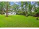 View of white house and lush green backyard at 106 N Pine St, Summerville, SC 29483