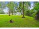Large backyard features green lawn and mature trees at 106 N Pine St, Summerville, SC 29483